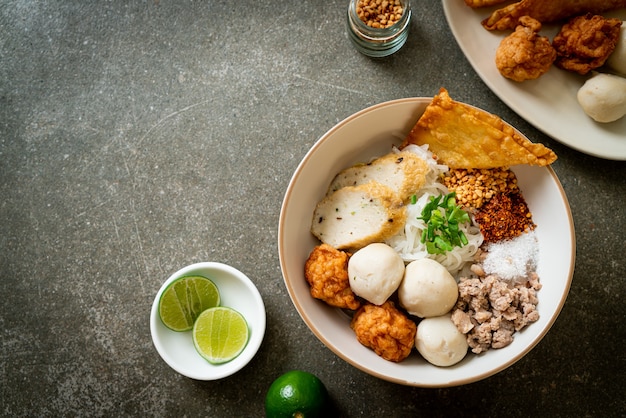 spicy small flat rice noodles with fish balls and shrimp balls without soup - Asian food style