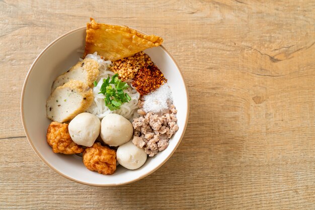 spicy small flat rice noodles with fish balls and shrimp balls without soup - Asian food style