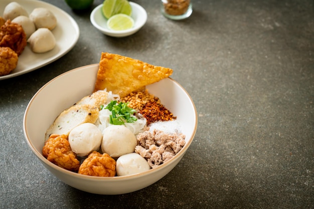 spicy small flat rice noodles with fish balls and shrimp balls without soup