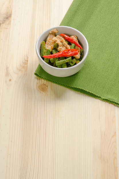 Spicy stir fried pork with red curry paste and Yard Long bean, Thai food menu