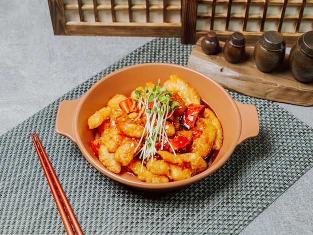 Spicy sweet and sour pork dish served on a plate