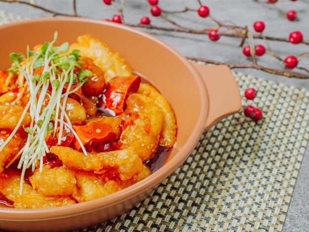 Spicy sweet and sour pork dish served on a plate