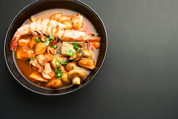 Spicy Thai seafood soup tom yam kung in a bowl