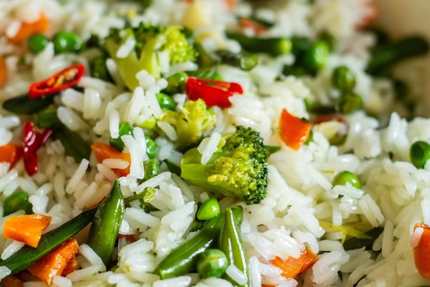 Spicy vegetarian dish with rice, broccoli, green beans and peas