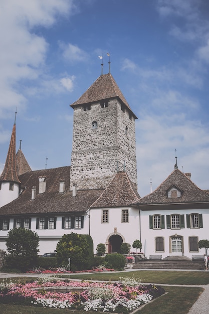 Spiez, Switzerland - June 22, 2017: View on Spiez Castle - living museum and park, Switzerland, Europe. It is a Swiss heritage site of national significance. Summer landscape and blue sky