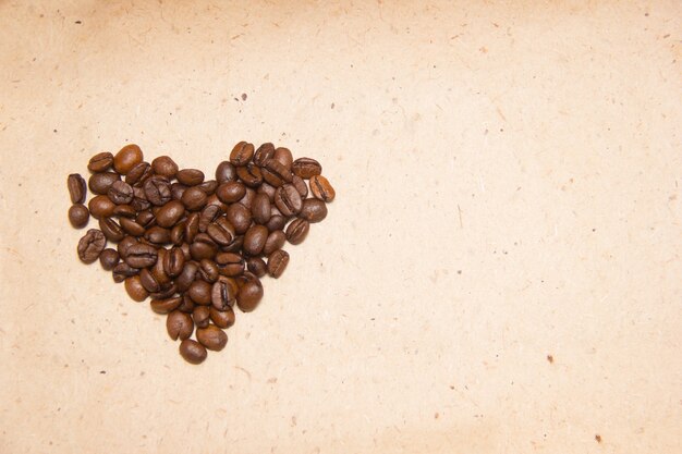 Spilled coffee beans. Coffee in the form of hearts. Wrapping paper