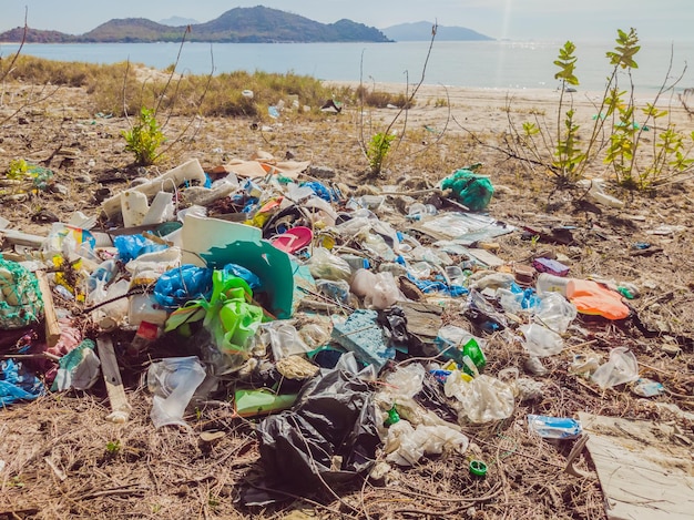 Spilled garbage on the beach Empty used plastic boxes and ropes Dirty sea sandy shore Environmental pollution Ecological problem Ocean Dumping Total pollution