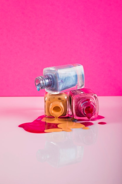 Photo spilled nail polish isolated on pink background