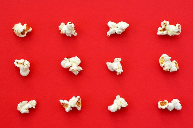 Spilled popcorn on red background pattern