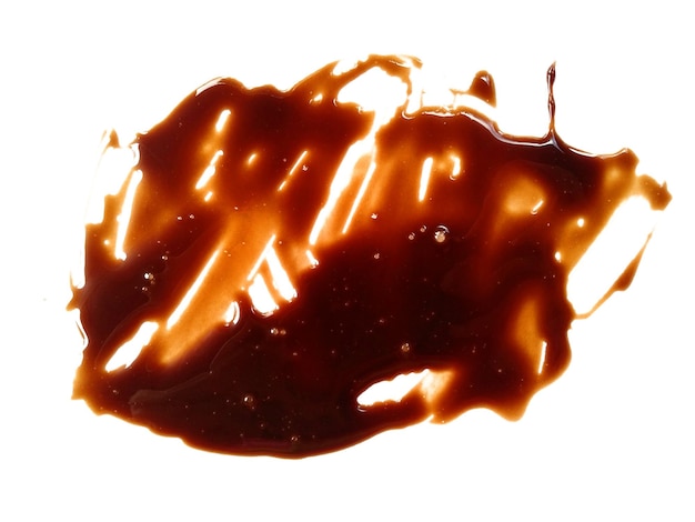Spilled soy sauce sauce puddle Texture of spilled soy sauce Soy sauce on white background