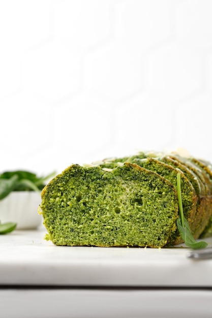 Spinach cake cutted on marble board Pieces of Sponge green pie Green cake texture