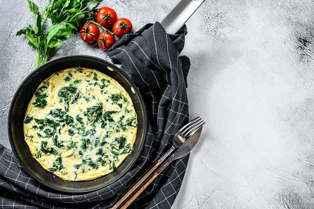 Spinach cheese frittata in a pan.