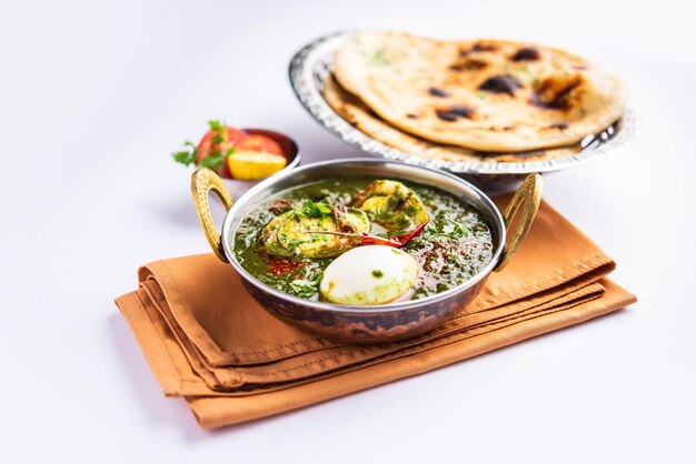 Spinach egg curry is an Indian non vegetarian dish made using palak gravy with eggs