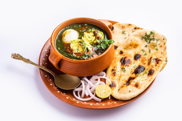 Spinach egg curry is an Indian non vegetarian dish made using palak gravy with eggs