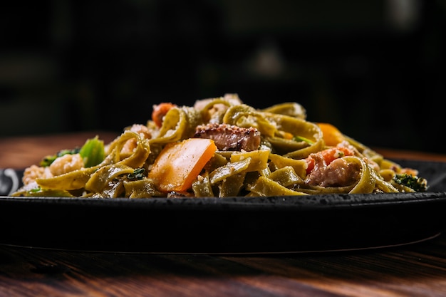 Spinach fettuccine pasta with beef and vegetables