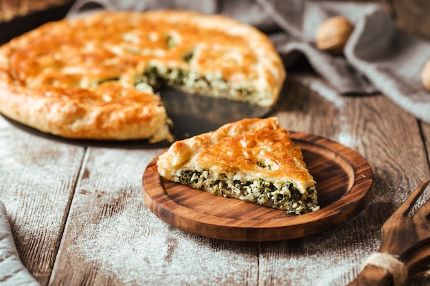 Spinach filling pie on the wooden rustic table