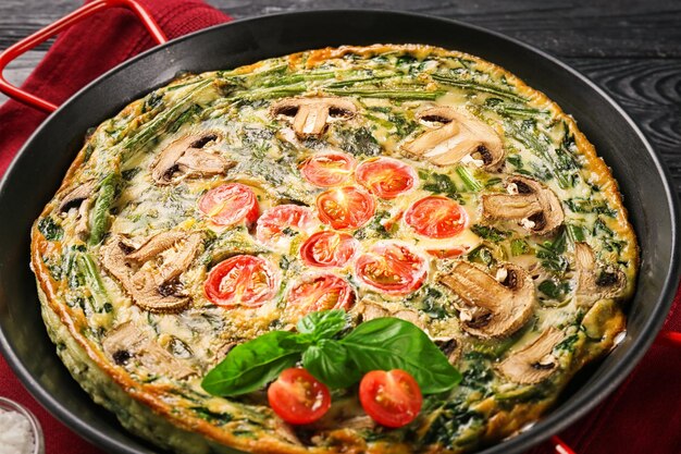 Spinach frittata in frying pan closeup