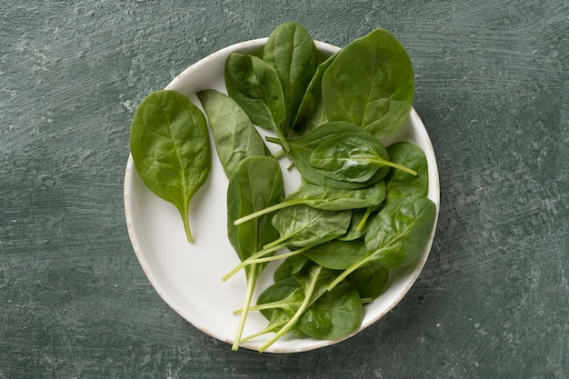 Spinach juicy leaves on a white plate