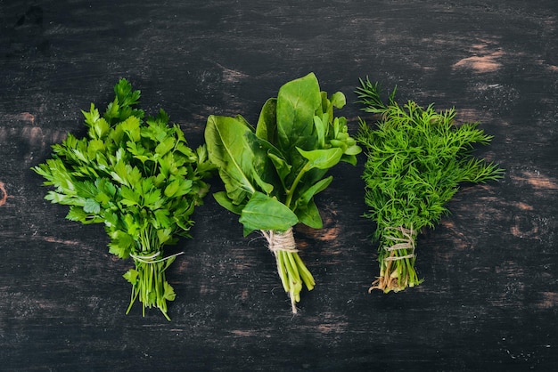 Spinach Parsley and Dill On a wooden background Top view Copy space