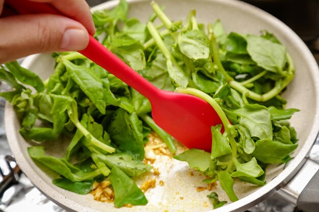 Spinach in the pot smothered with garlic and oil ready to serve a delicious dish