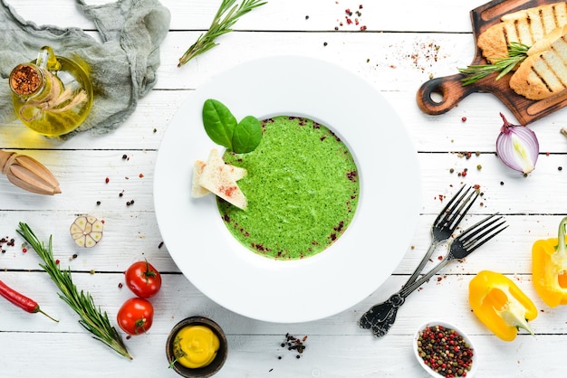 Spinach puree soup in a plate top view free copy space