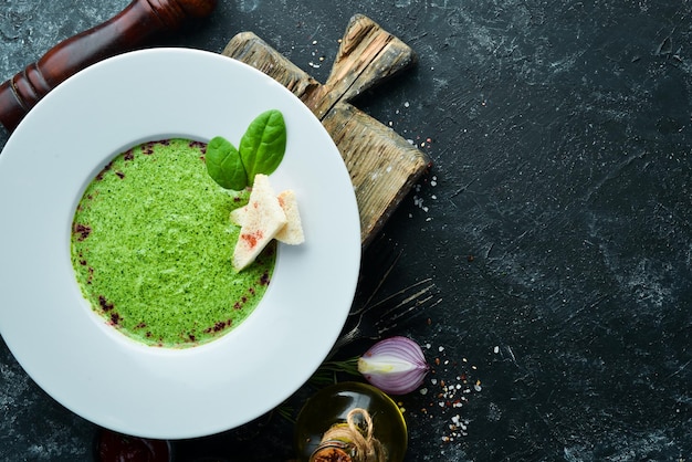 Spinach puree soup in a plate Top view Free copy space