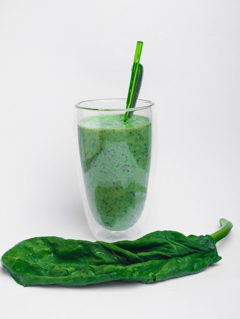 Spinach smoothie isolated on white with copy space