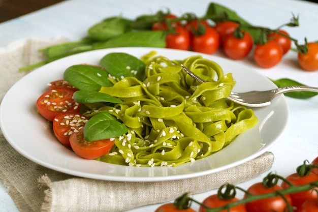 Spinach tagliatelle with cherry tomatoes. proper diet.