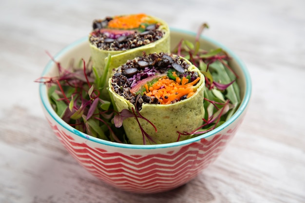 Photo spinach wrap stuffed with norwegian salmon. seen from above.