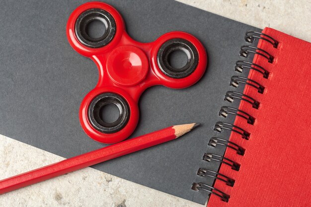 Spinner, notebook and pencil on the table