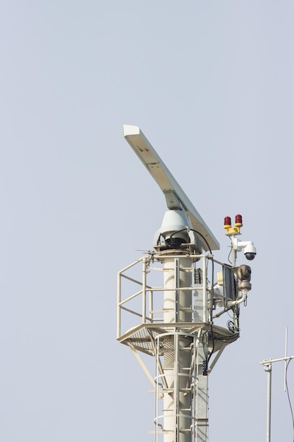 Spinning rotating radar equipment on top of a ship  in front of the sky