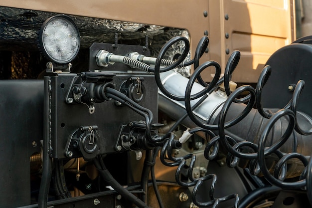 Spiral cable connecting truck cabin and trailer pneumatic hoses\
and electric cables on the coupler of the hitch between a tractor\
truck and its semitrailer hydraulic control system in new cars