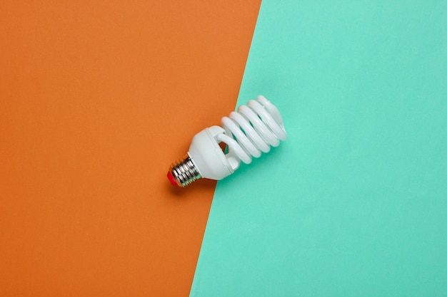 Spiral eco light bulb on a colored paper