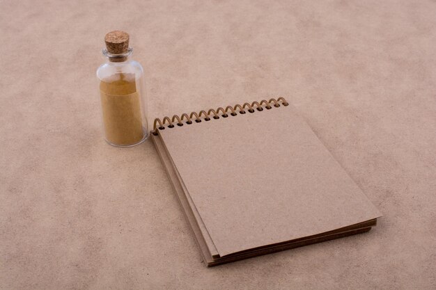 Spiral notebook and a bottle