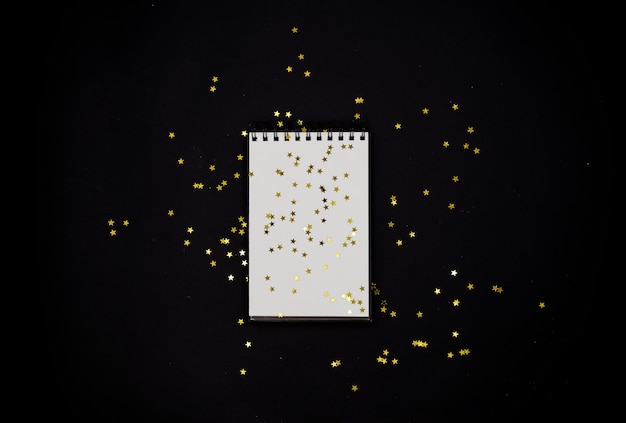 Spiral Notebook golden stars confetti.Horizontal top view.