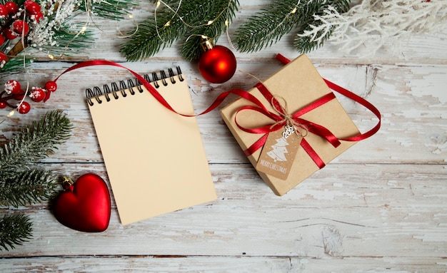 spiral notepad on wooden background with christmas decorations