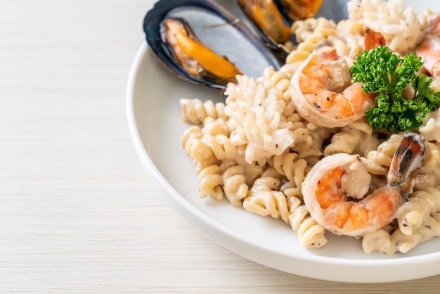 spiral pasta mushroom cream sauce with seafood - Italian food style