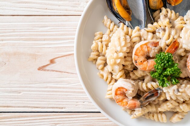 spiral pasta mushroom cream sauce with seafood - Italian food style