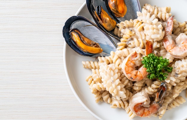 spiral pasta mushroom cream sauce with seafood - Italian food style