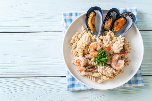 spiral pasta mushroom cream sauce with seafood - Italian food style