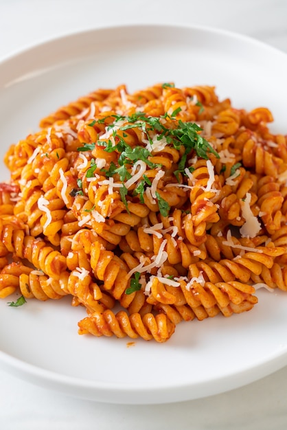 Spiral or spirali pasta with tomato sauce and cheese - italian food style
