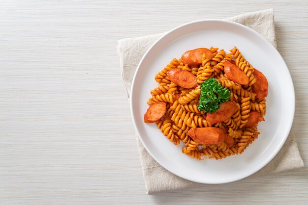 spiral or spirali pasta with tomato sauce and sausage - Italian food style