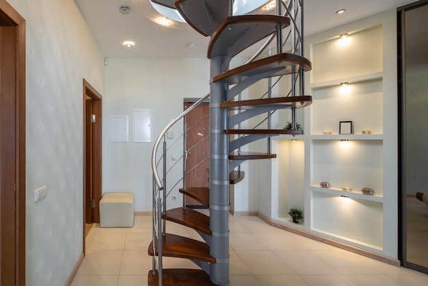 Spiral staircase to second floor in hall of modern luxury apartment Private house