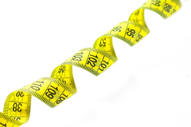 spiral of yellow measuring measure tape isolated on white background