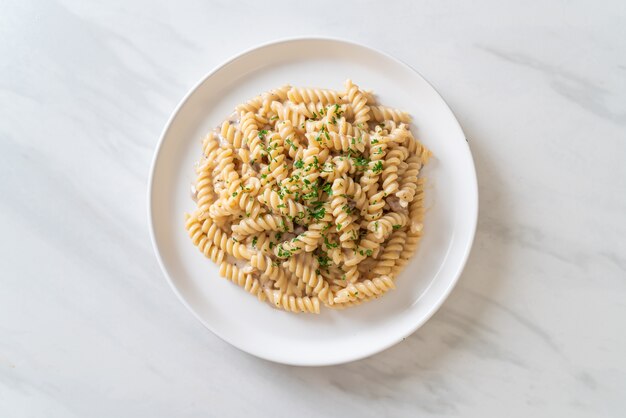 spirali or spiral pasta mushroom cream sauce with parsley - Italian food style