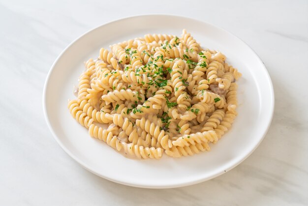 spirali or spiral pasta mushroom cream sauce with parsley - Italian food style