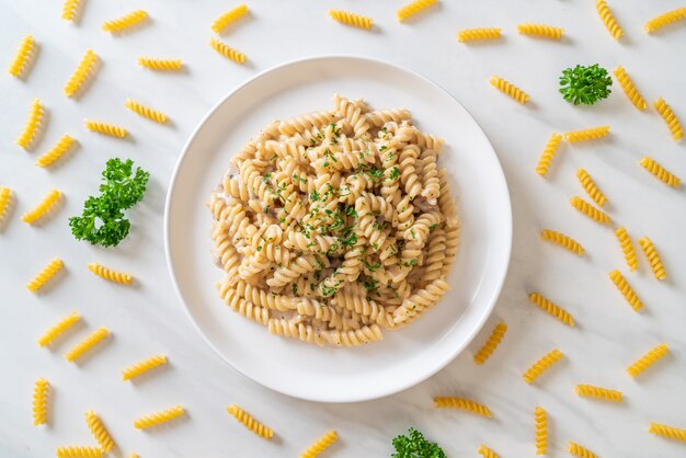 spirali or spiral pasta mushroom cream sauce with parsley - Italian food style