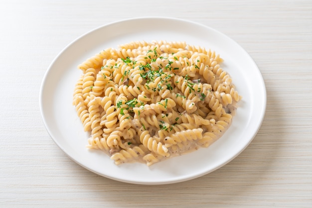 spirali or spiral pasta mushroom cream sauce with parsley - Italian food style