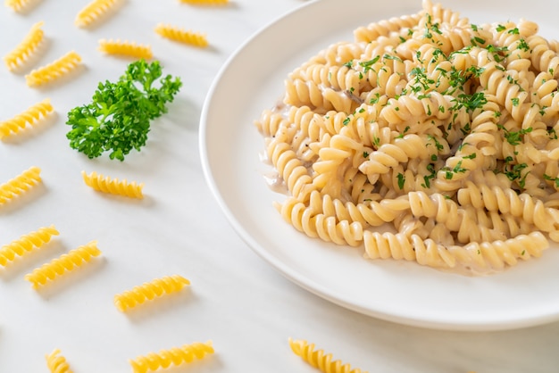 spirali or spiral pasta mushroom cream sauce with parsley. Italian food style