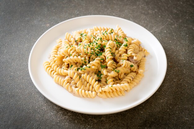 spirali or spiral pasta mushroom cream sauce with parsley - Italian food style